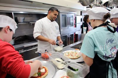 Students participating in pizza-making contest